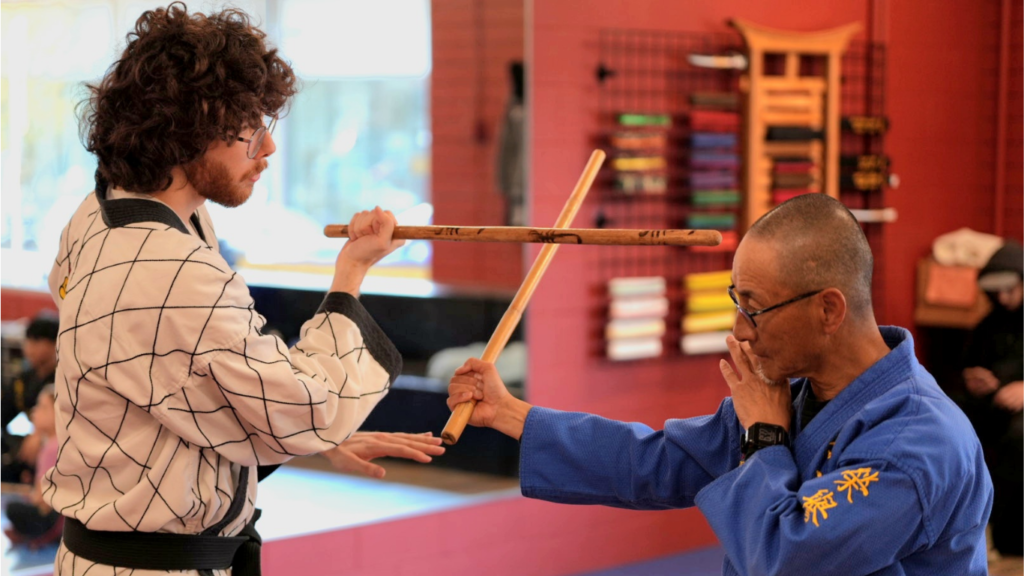 A Master instructor demonstrating advanced Arnis stick-fighting blocks and counters.