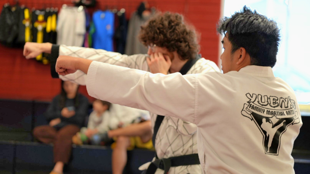 Adult students practicing punches during a Tae Kwon Do class at Yuen's Family Martial Arts in Coquitlam.