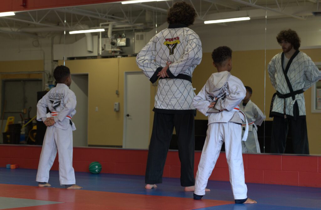 An instructor leading young students in a discipline drill at Yuen's Family Martial Arts in Coquitlam.